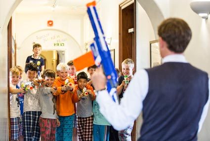 Pupils and teacher at Aysgarth School engage in a nerf gun battle